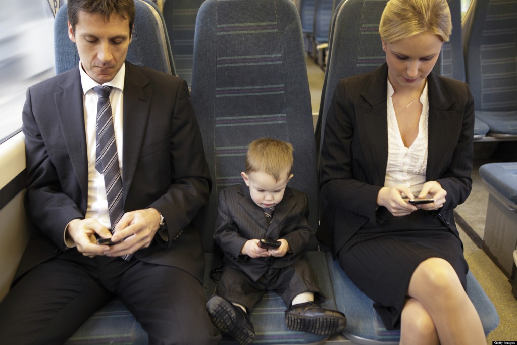 two adults and one baby executive sat on train